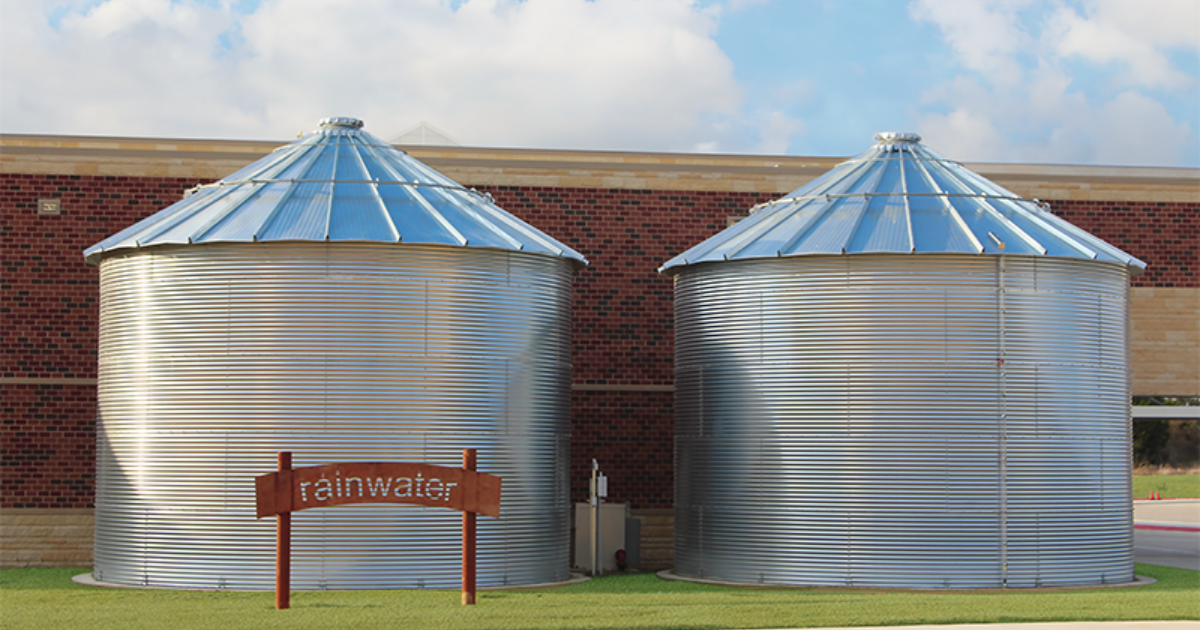 Photograph of two CorGal® rainwater harvesting tanks installed at a local school for rainwater collection and reuse. Source: intellectual property of Water Storage Tanks, Inc.