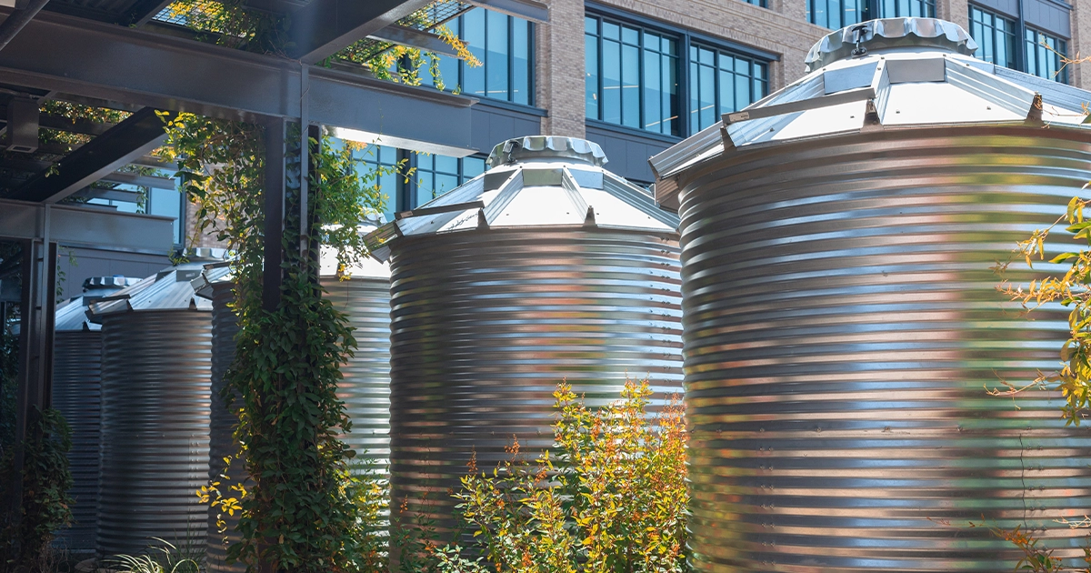 Photo of a series of CorGal® rainwater harvesting tanks adjacent to each other, promoting water reuse for a business in Central Texas. As the intellectual property of Water Storage Tanks, Inc., this image is subject to copyright.