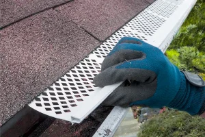 Photo of a rain gutter filter being installed. As the intellectual property of Water Storage Tanks, Inc., this image is subject to copyright.