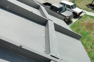 Photo of a CorGal rainwater harvesting tank with a rainwater catchment dam on the roof. As the intellectual property of Water Storage Tanks, Inc., this image is subject to copyright.